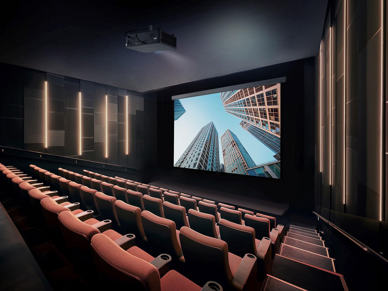 Large-scale projector setup for an auditorium event.
