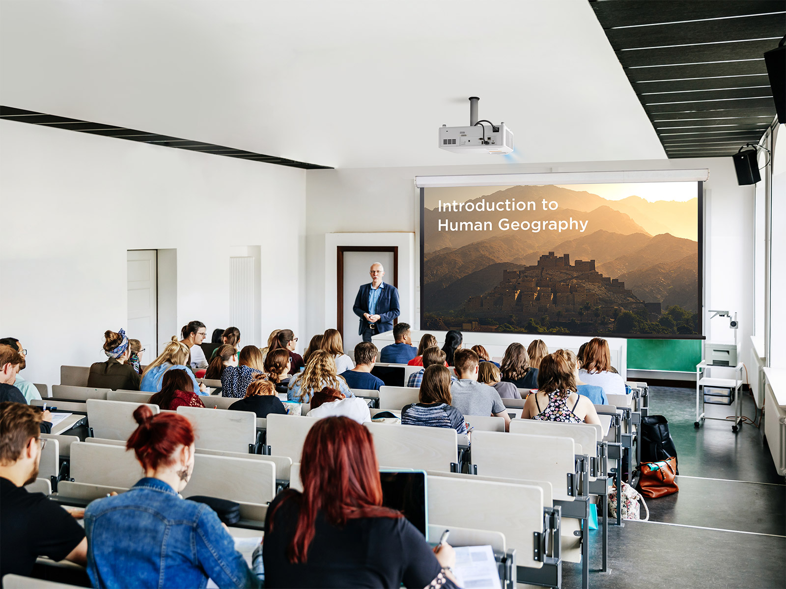 Lecture hall equipped with a large projector display.